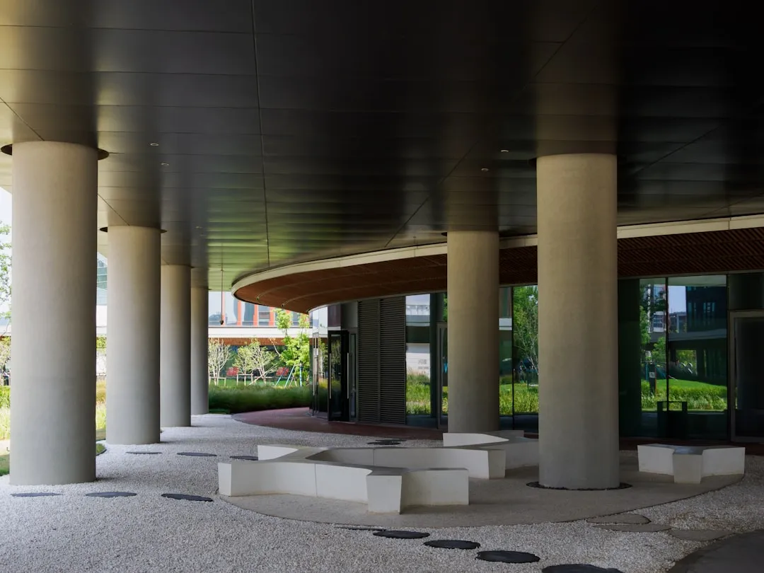 A row of white pillars sitting next to a building