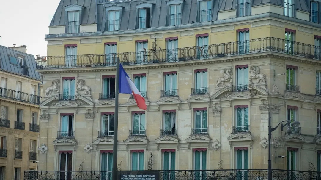 a large building with a flag flying in front of it