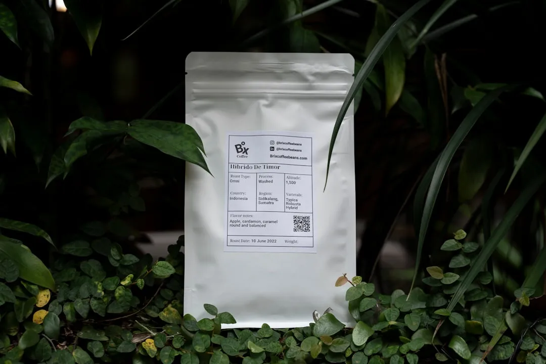 a white bag with a label on it surrounded by plants