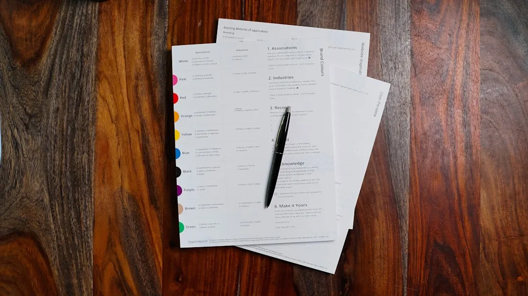 a stack of papers sitting on top of a wooden table