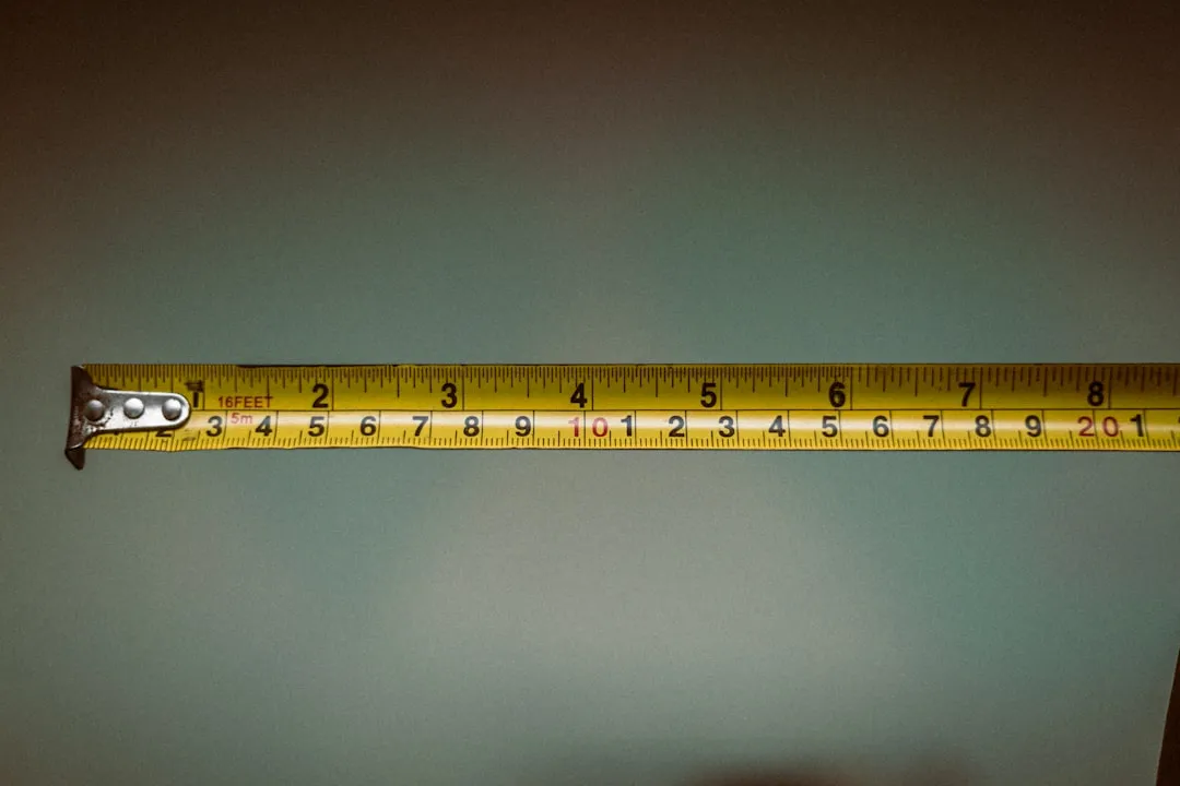 a person holding a tape measure in their hand