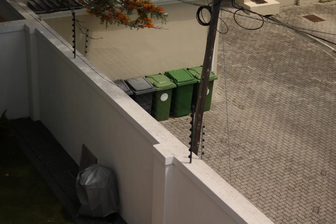 a trash can sitting on the side of a building