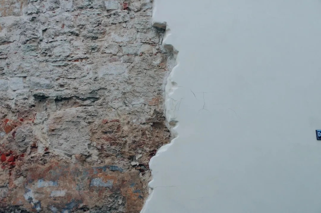 a white wall with a blue sign on it